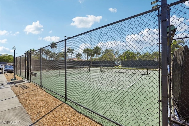 view of sport court featuring fence