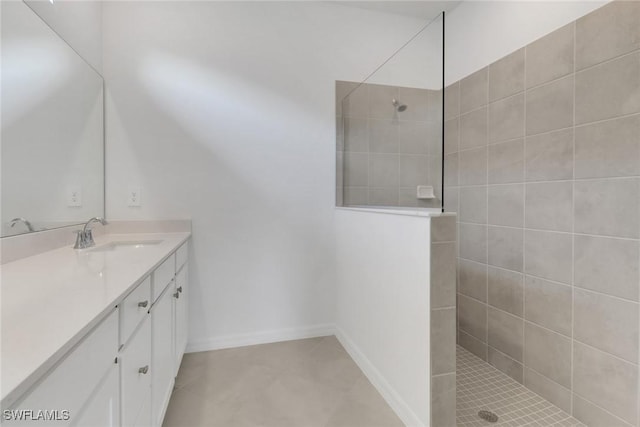 full bathroom with baseboards, walk in shower, and vanity