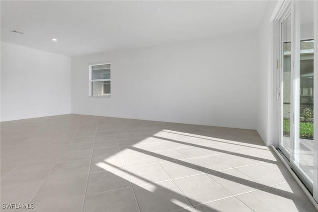 tiled spare room featuring recessed lighting