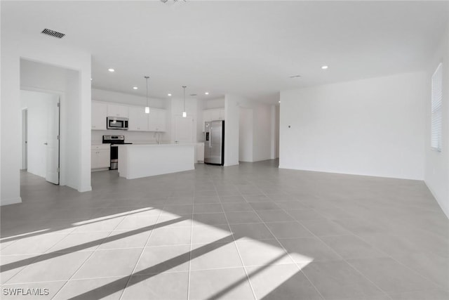 unfurnished living room with recessed lighting, visible vents, and light tile patterned flooring