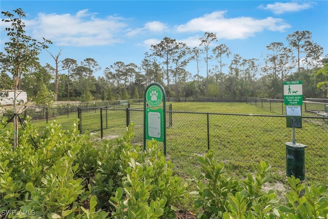 view of community featuring fence and a lawn