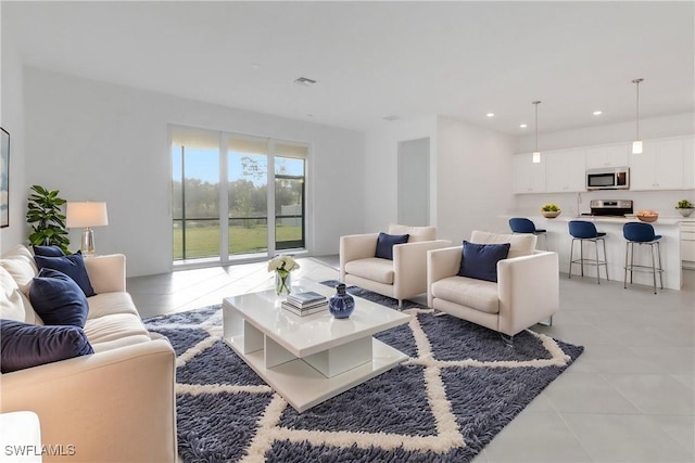 living room with light tile patterned floors, visible vents, and recessed lighting