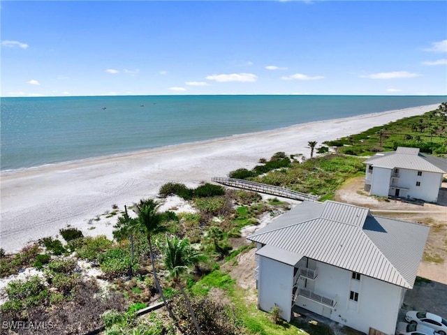 aerial view with a water view and a beach view