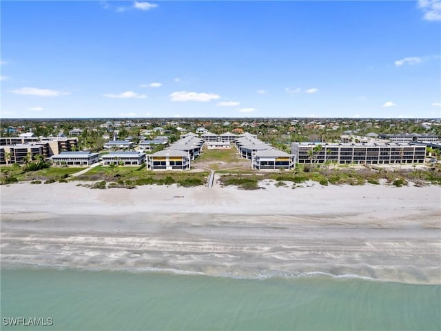 bird's eye view featuring a water view and a beach view