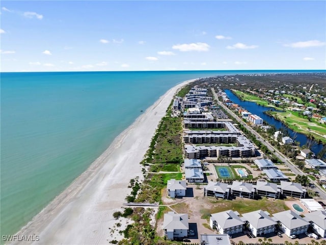 birds eye view of property featuring a water view and a beach view