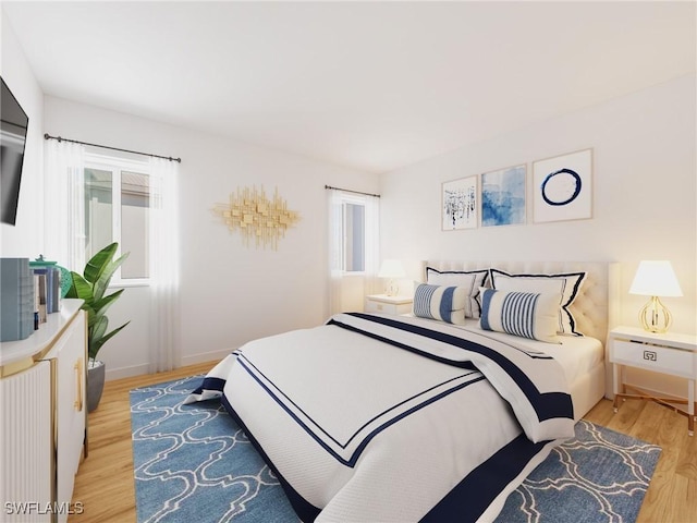 bedroom with light wood-style flooring and baseboards