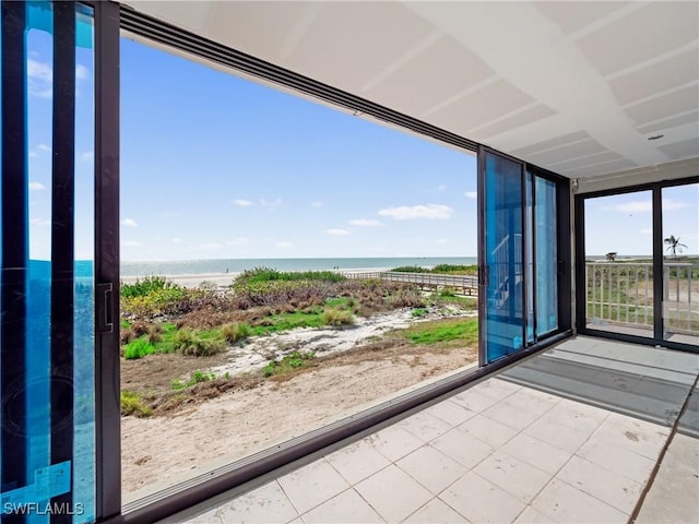 unfurnished sunroom featuring a water view and a wealth of natural light