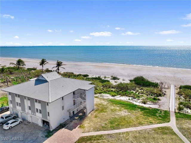 drone / aerial view with a beach view and a water view