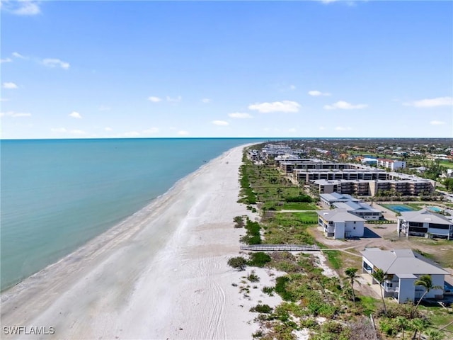 birds eye view of property with a beach view and a water view