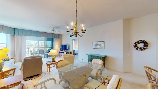 dining room with light colored carpet and ceiling fan with notable chandelier