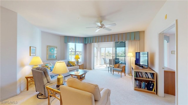 living area with carpet floors and ceiling fan