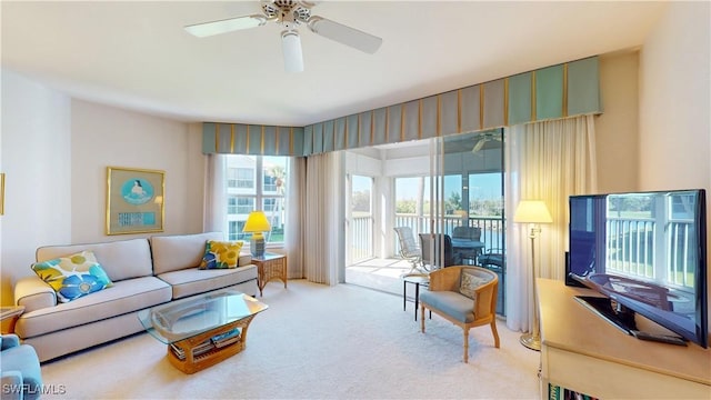 living room featuring a ceiling fan and carpet flooring