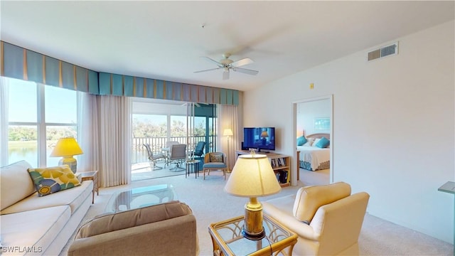 living room featuring a ceiling fan, carpet flooring, and visible vents