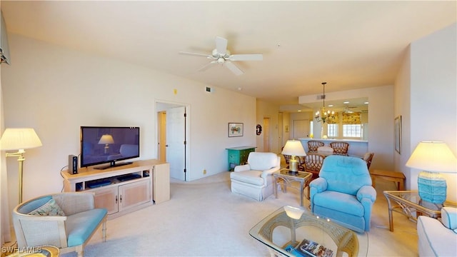 living room with ceiling fan with notable chandelier and carpet flooring