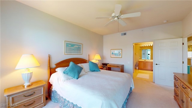 bedroom with visible vents, ceiling fan, light carpet, and ensuite bathroom