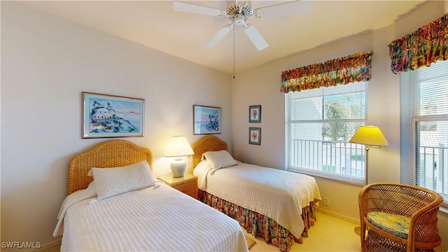 carpeted bedroom with ceiling fan and baseboards