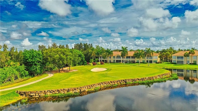 view of home's community featuring view of golf course, a water view, and a lawn