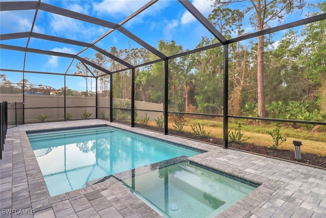 view of swimming pool with a patio area, a lanai, and a pool with connected hot tub