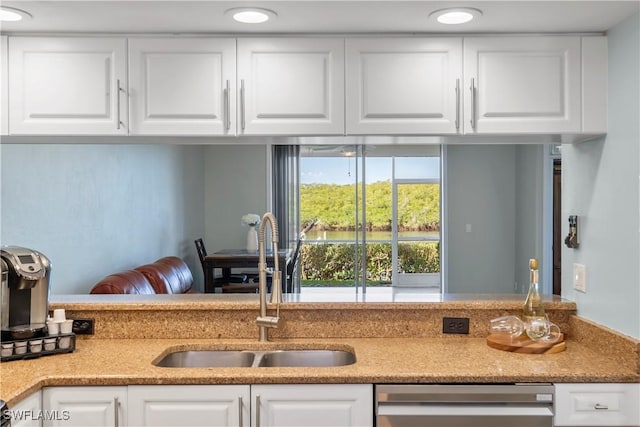 kitchen featuring recessed lighting, white cabinetry, a sink, and stainless steel dishwasher