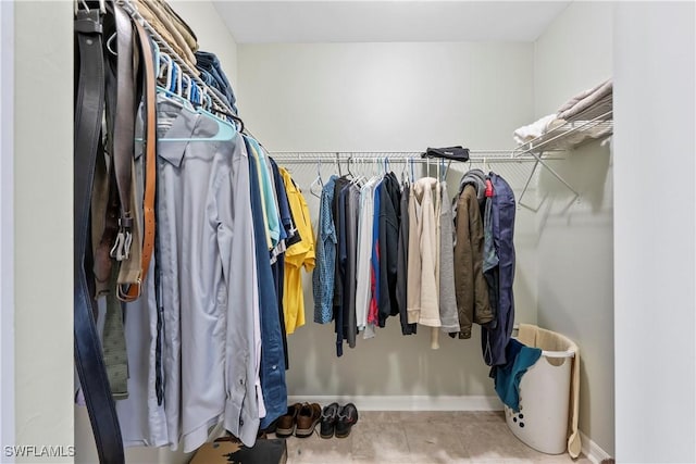 walk in closet with tile patterned floors