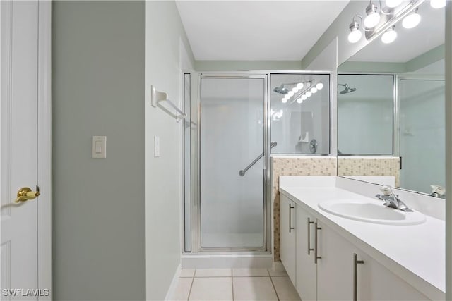 full bath with tile patterned flooring, vanity, and a shower stall