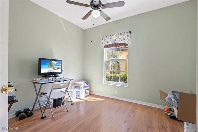 office featuring wood finished floors, a ceiling fan, and baseboards