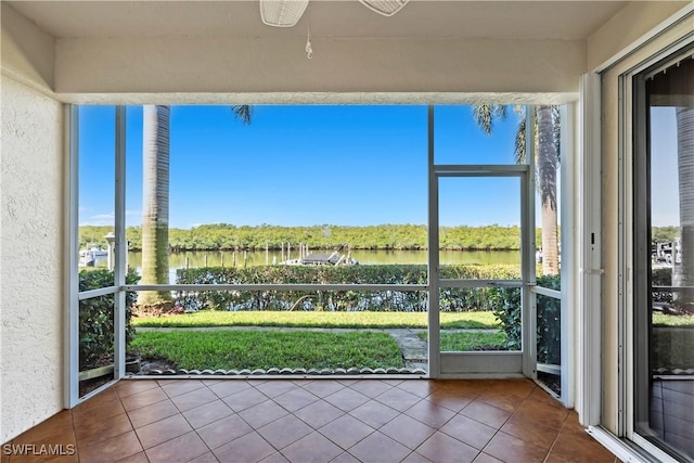 unfurnished sunroom with plenty of natural light and a water view