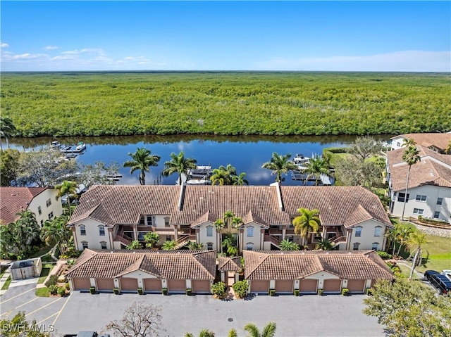 birds eye view of property with a water view and a residential view