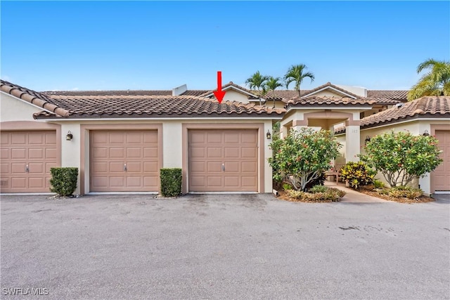 view of front of house featuring community garages and stucco siding