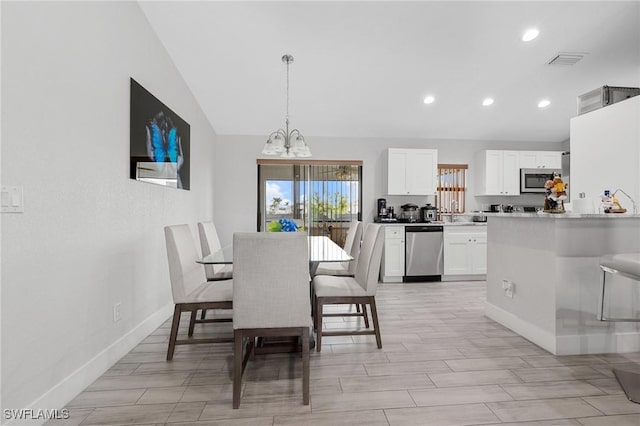 dining room featuring recessed lighting, visible vents, vaulted ceiling, a chandelier, and baseboards