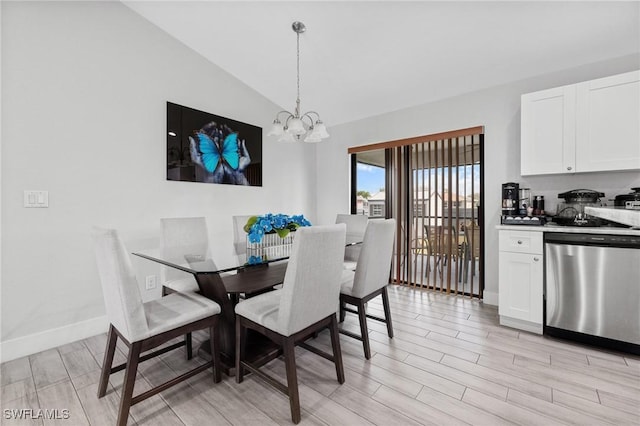 dining room featuring wood tiled floor, vaulted ceiling, baseboards, and an inviting chandelier