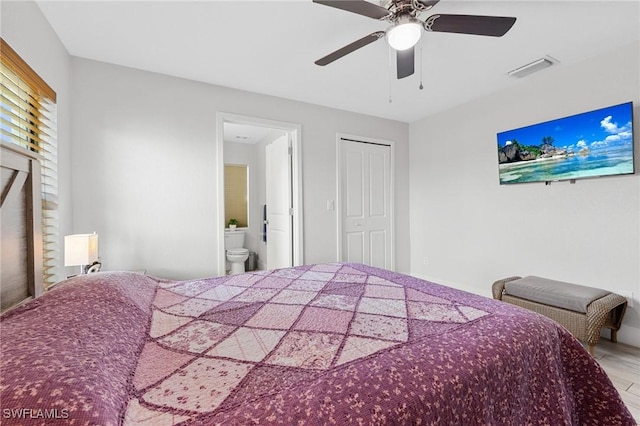 bedroom with a closet, connected bathroom, visible vents, and a ceiling fan