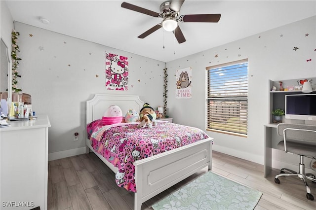 bedroom with light wood-type flooring, ceiling fan, and baseboards