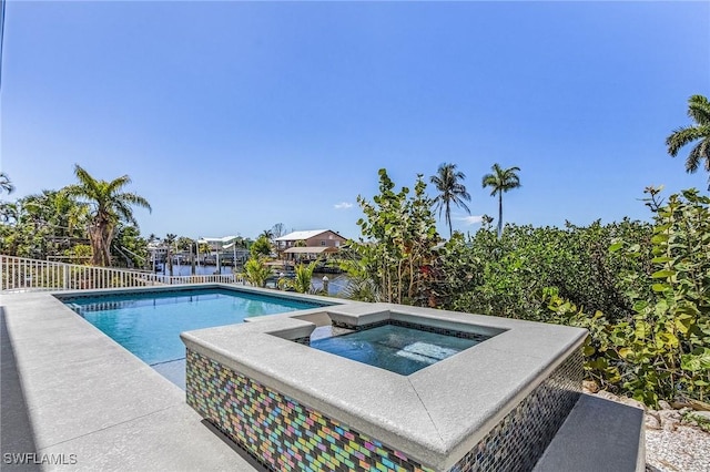 view of pool featuring a fenced in pool and an in ground hot tub