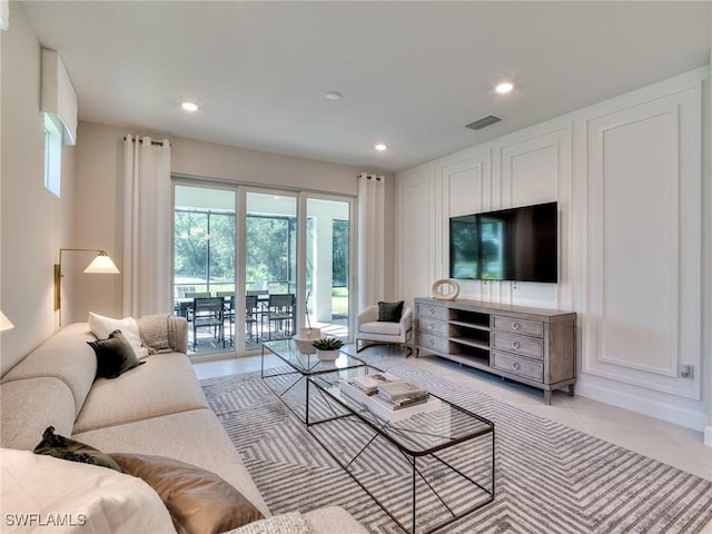 living area with recessed lighting, visible vents, and light tile patterned flooring