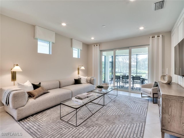 living area featuring a healthy amount of sunlight, recessed lighting, visible vents, and light tile patterned flooring