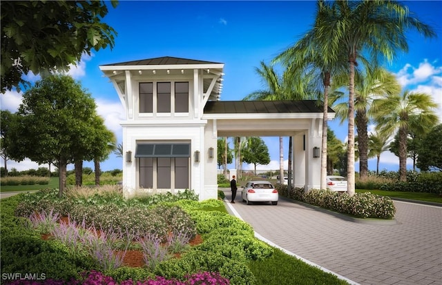 17333 Leaning Oak Trl, North Fort Myers, FL 33917 - view of front of property with a standing seam roof, metal roof, driveway, an attached carport, and stucco siding