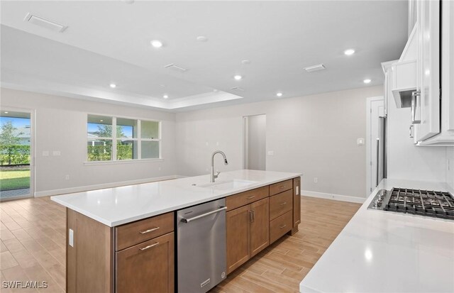 17333 Leaning Oak Trl, North Fort Myers, FL 33917 - kitchen featuring stainless steel appliances, a sink, light wood-style floors, a center island with sink, and light countertops