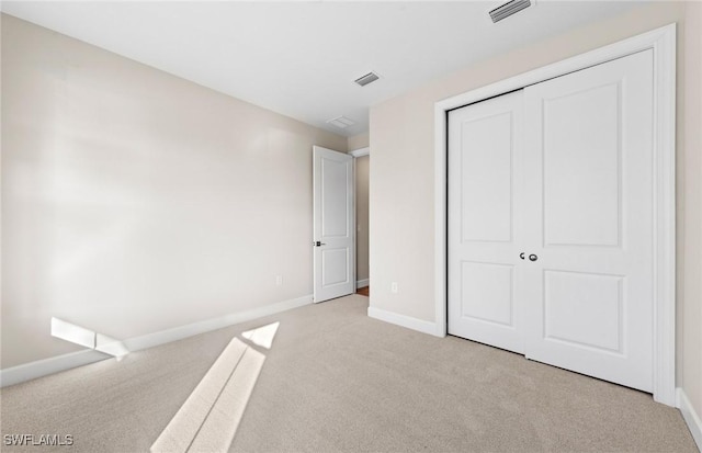 17333 Leaning Oak Trl, North Fort Myers, FL 33917 - unfurnished bedroom featuring light colored carpet, baseboards, and a closet
