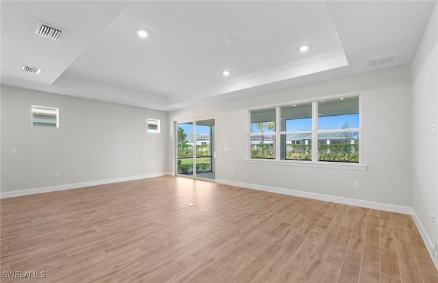 17333 Leaning Oak Trl, North Fort Myers, FL 33917 - unfurnished room featuring a tray ceiling, baseboards, light wood-style floors, and recessed lighting
