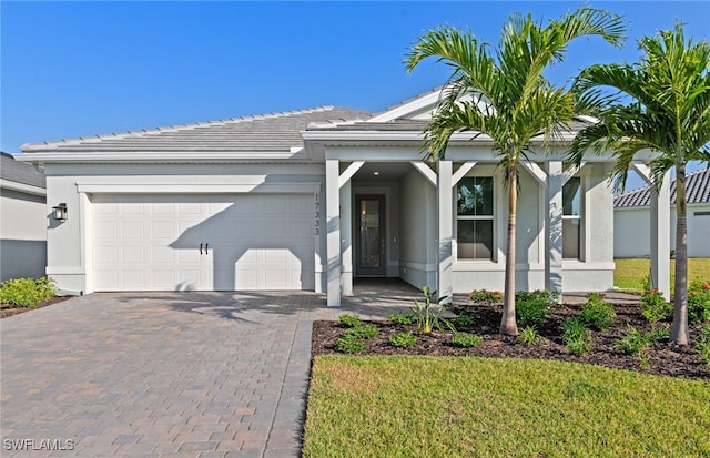 17333 Leaning Oak Trl, North Fort Myers, FL 33917 - single story home featuring a tiled roof, a garage, driveway, and stucco siding