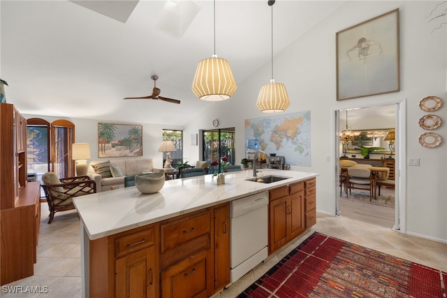 kitchen with decorative light fixtures, a sink, open floor plan, dishwasher, and a center island with sink