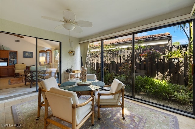 sunroom / solarium featuring visible vents and ceiling fan