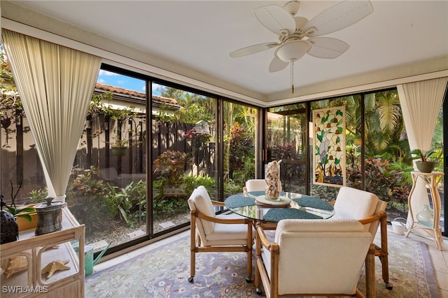 sunroom / solarium with a ceiling fan