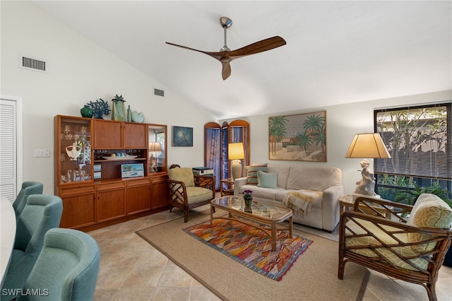 living area with arched walkways, light tile patterned floors, visible vents, and a ceiling fan