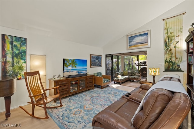 living room with high vaulted ceiling and wood finished floors