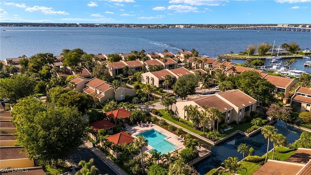 drone / aerial view with a residential view and a water view