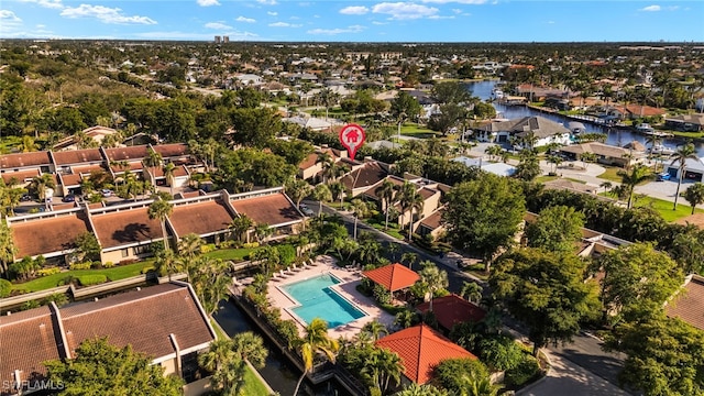 birds eye view of property with a water view and a residential view