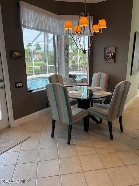 dining area featuring light tile patterned floors, plenty of natural light, a chandelier, and baseboards