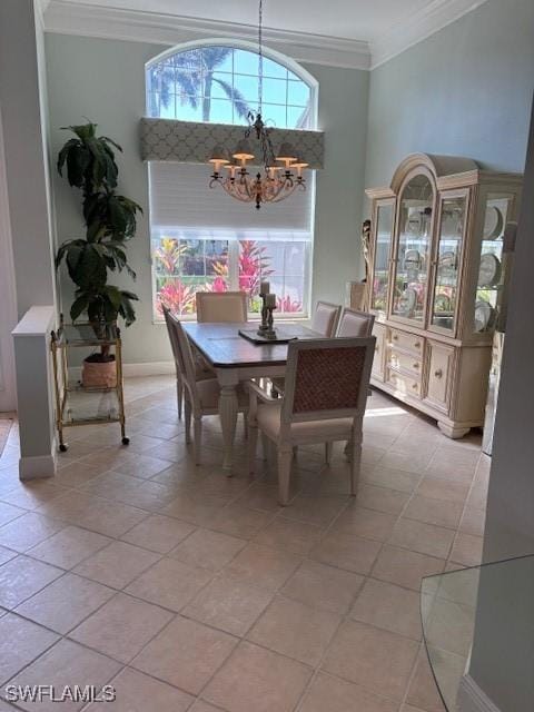 dining area featuring ornamental molding, light tile patterned flooring, baseboards, and a chandelier